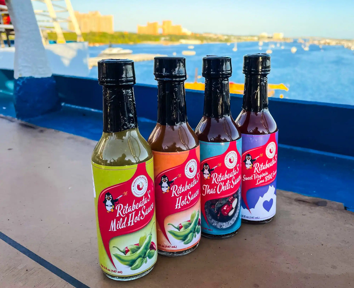 Four hot sauce bottles lined up with colorful labels.