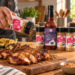 A hand holds a clear shaker of sweet virginia love bbq rub dispensing brown seasoning on grilled chicken Backyard BBQ Box