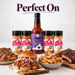 A tall slender bottle of sweet virginia love virginia love bbq sauce with a black cap and purple heart label from backyard bbq box