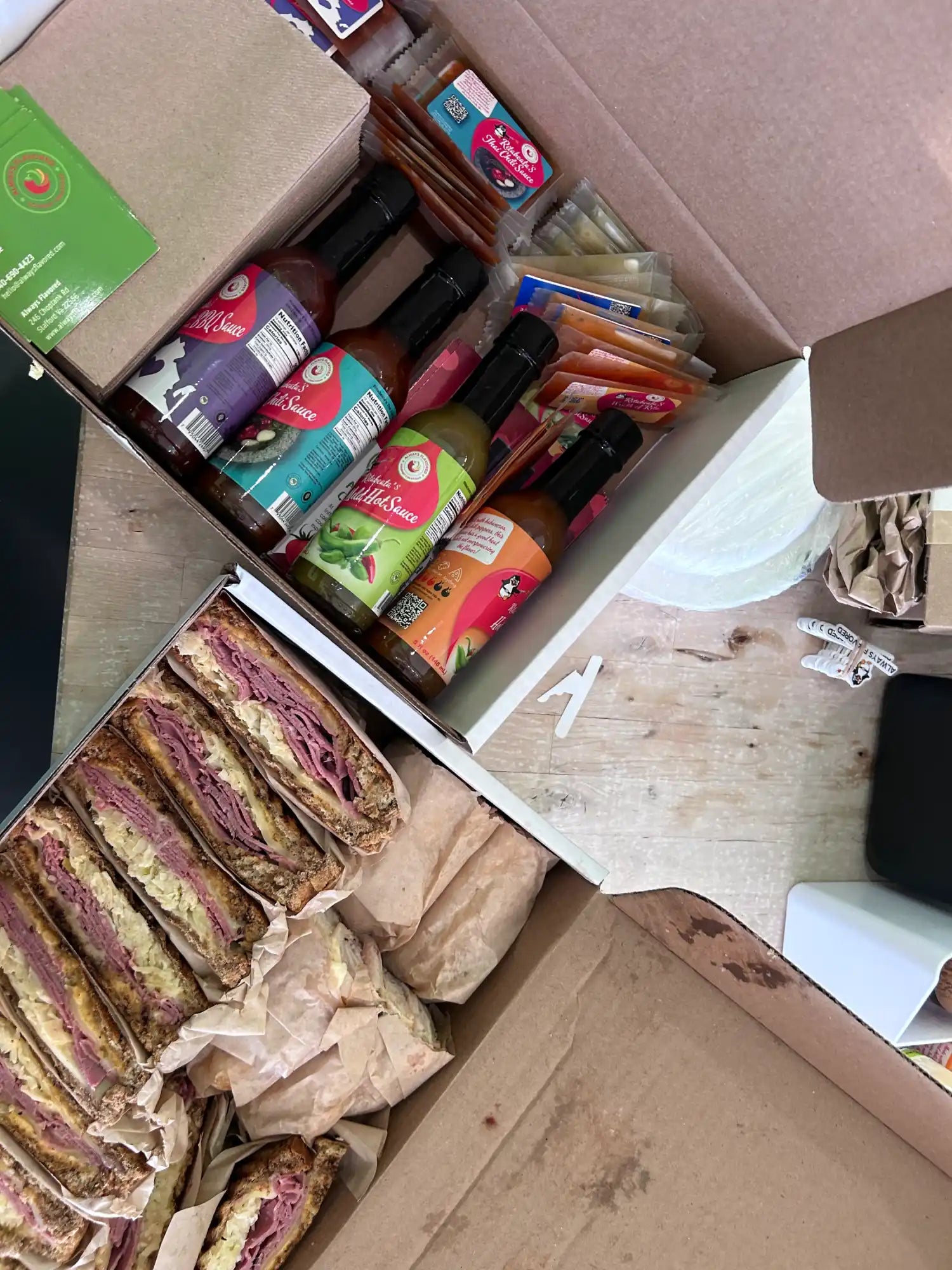 Box containing sandwiches and drinks.