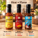 Three glass bottles of always flavored hot sauce with colorful labels and black caps in fafo heat pack product lineup