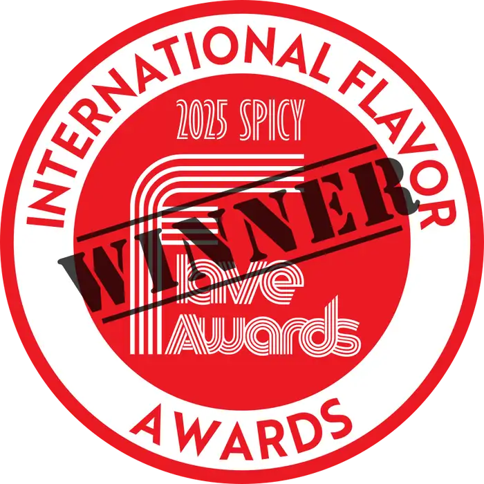 Red circular award seal with bold white text reading ’international flavor awards’ and a black diagonal stamp saying ’winner,’ featuring the year 2025 and category ’spicy.’