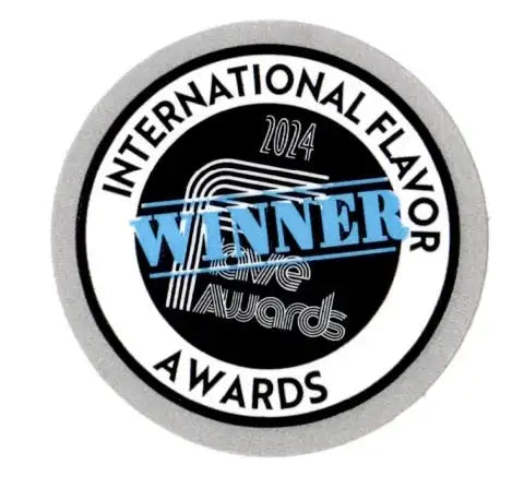 Silver circular award badge with black center, white text reading ’international flavor awards 2024,’ and a prominent blue “winner” stamp across the middle.